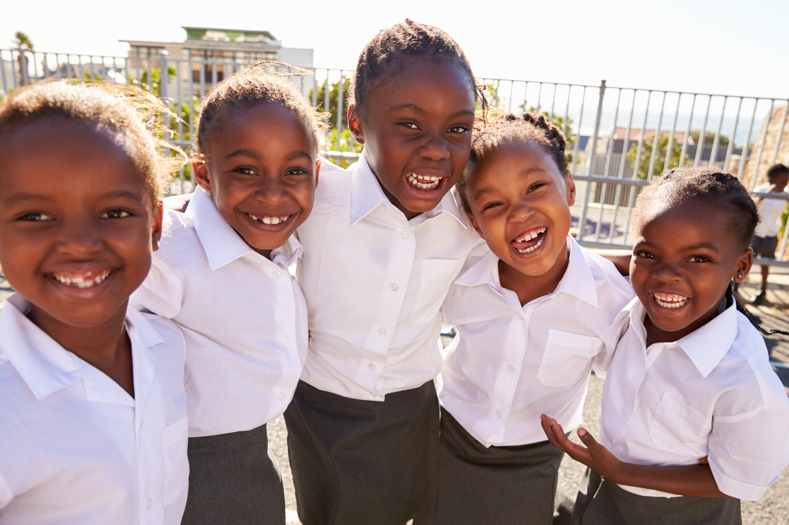 Young,African,Schoolgirls,In,Playground,Smiling,To,Camera