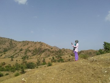 A nurse calling a doctor from top of the hill