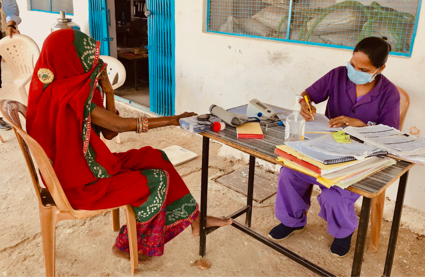 A primary healthcare nurse examines a woman with Rheumatoid Arthritis at Manpur