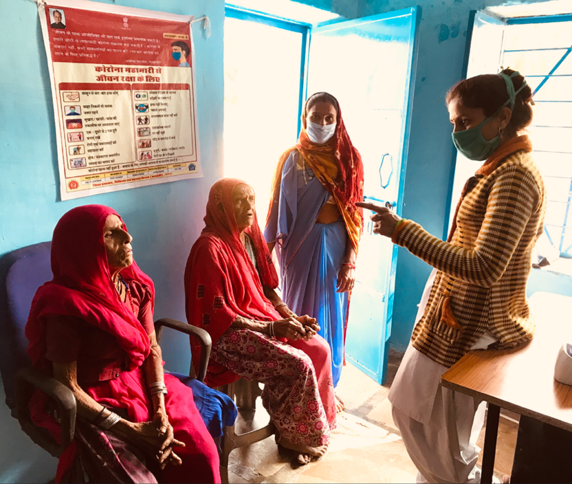 An CHW talks to elderly women at her sub-centre in a remote village in Rajasthan, India.